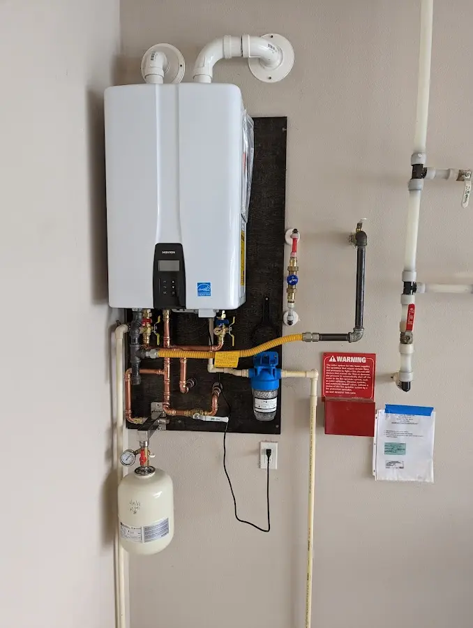 Professional plumber installing copper piping in a Coralville home